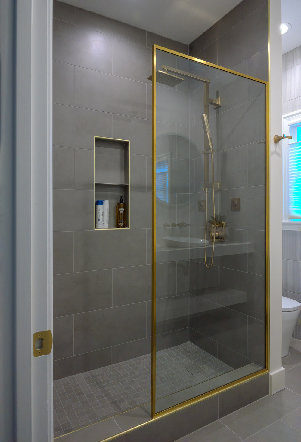 Walk-in shower with Schluter Quadec Brass trim.