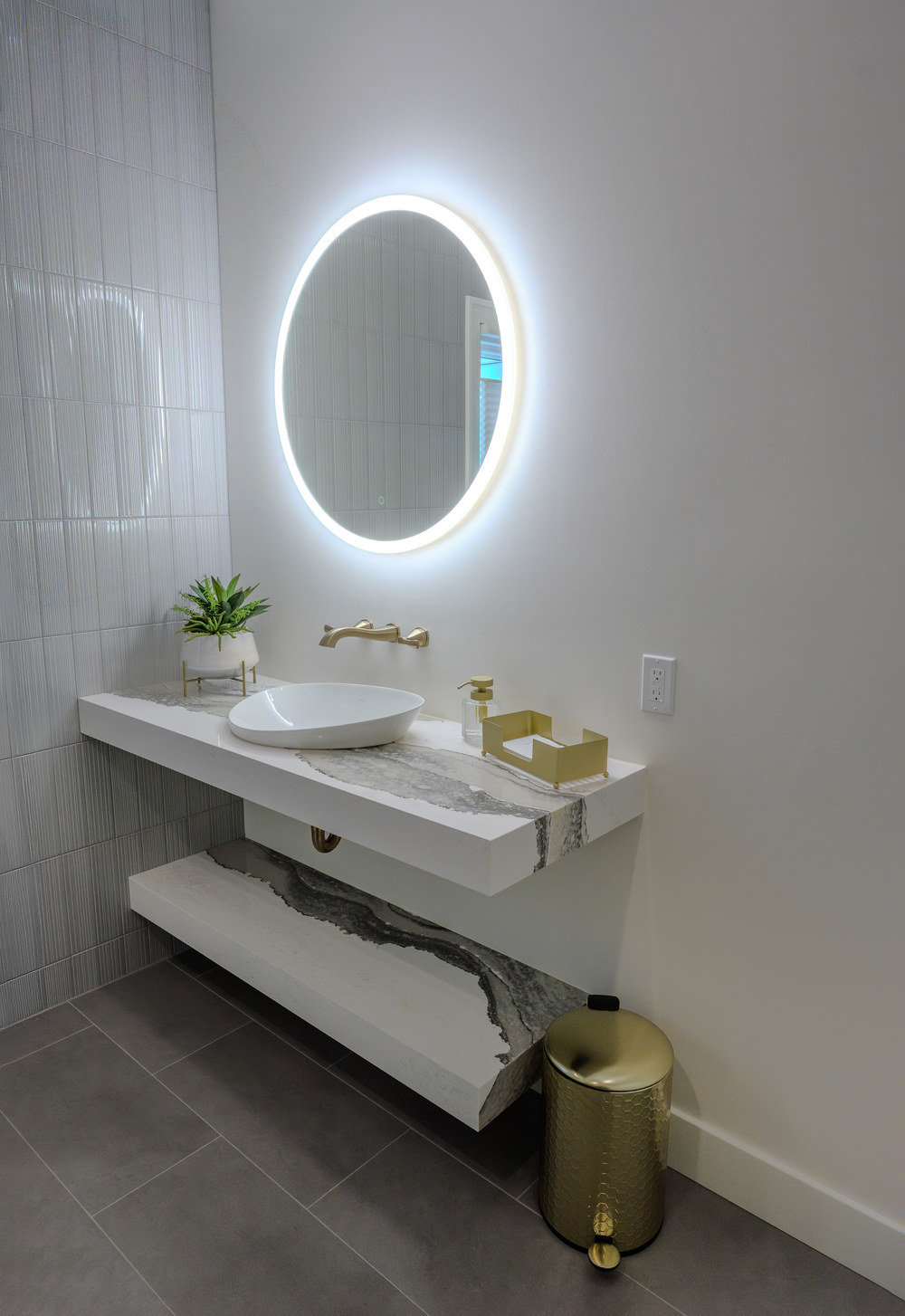 Floating Cambria vanity with Kohler vessel sink.