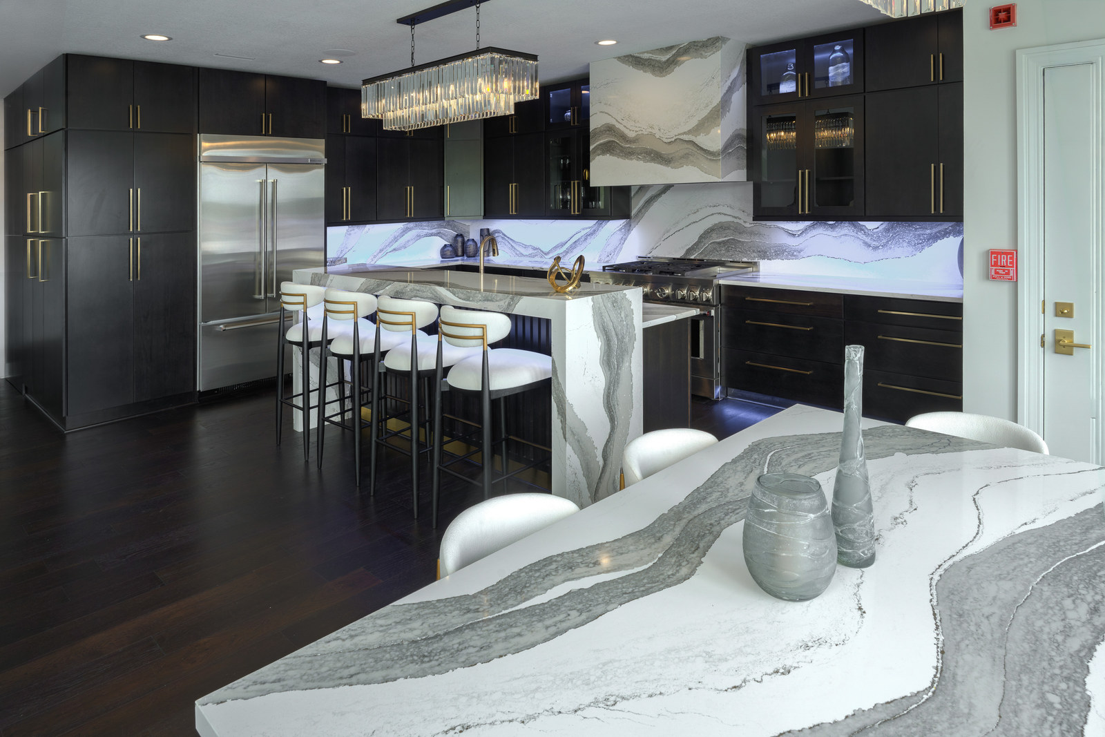 The finished kitchen: Cambria Skara Brae waterfall island and full-height backsplash.