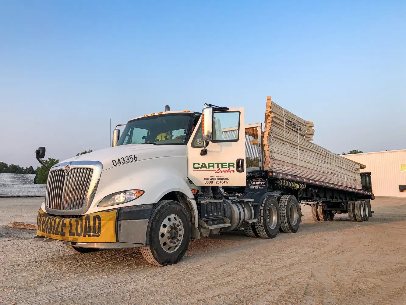 Carter Lumber semi truck with an oversize load of lumber on its flatbed