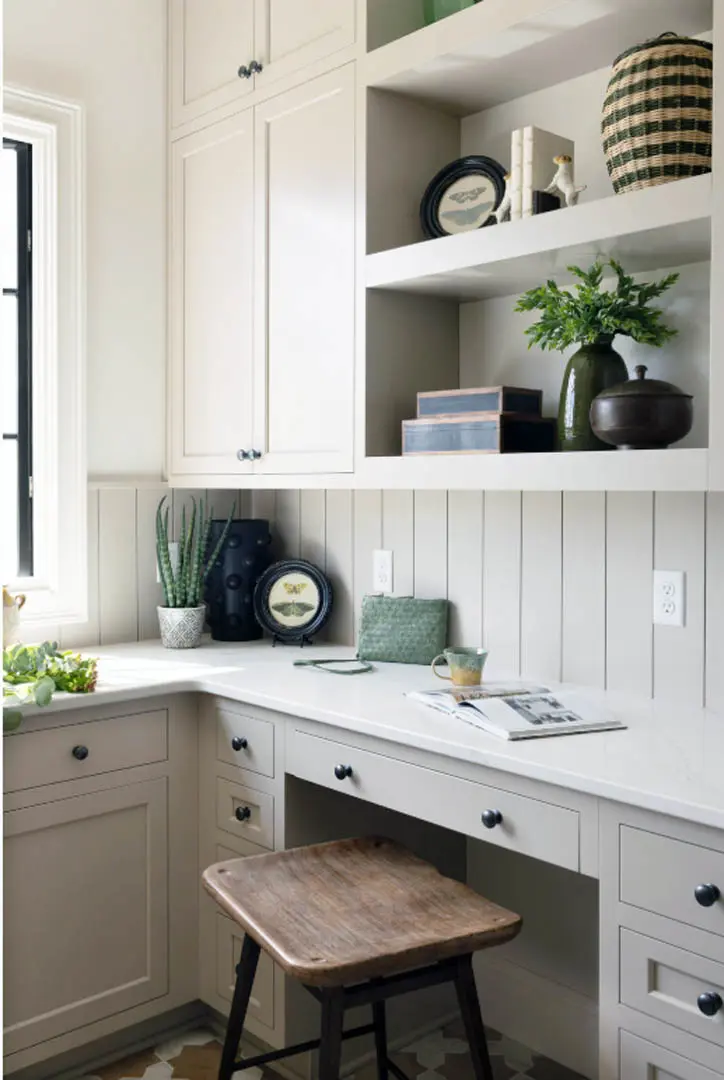 Built-in desk nook with greige cabinets, open shelves and vertical plank wall