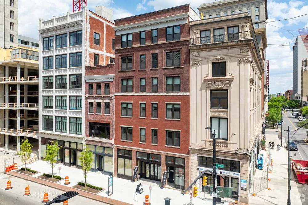 Restored brick and stone mid-rise buildings on a downtown street corner