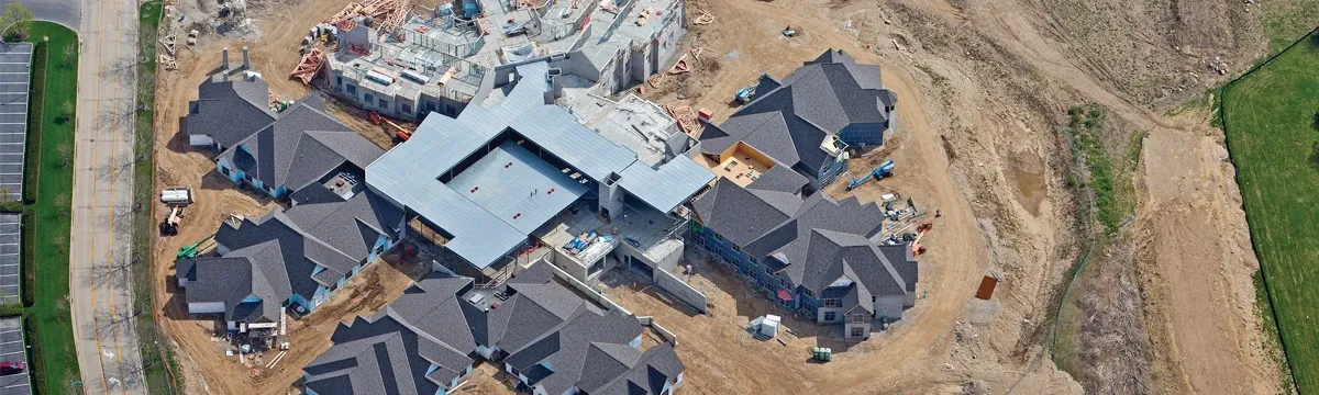 Aerial view of a large home under construction with roofing installed