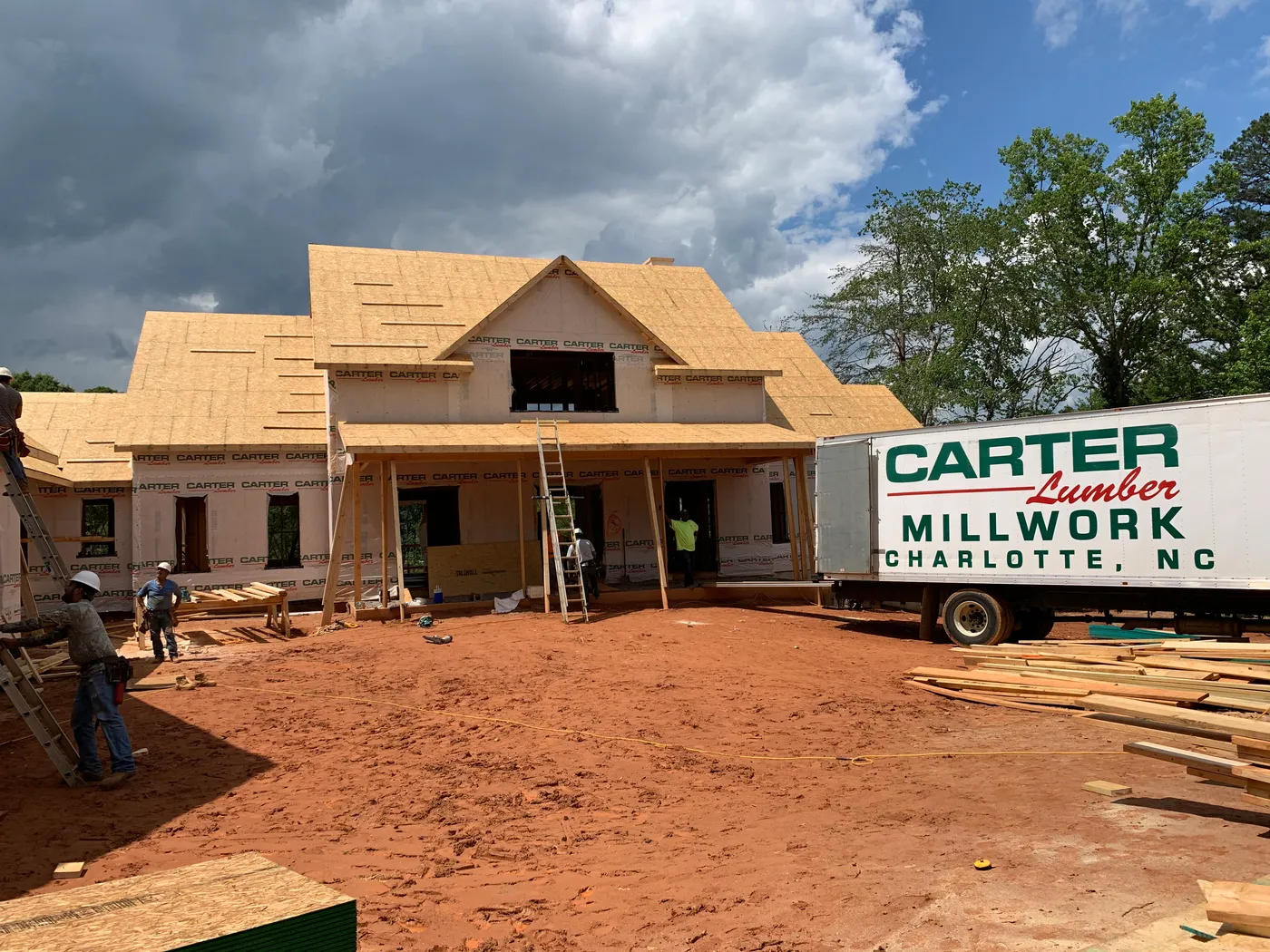 Carter Lumber Millwork Charlotte truck delivering to a house under construction