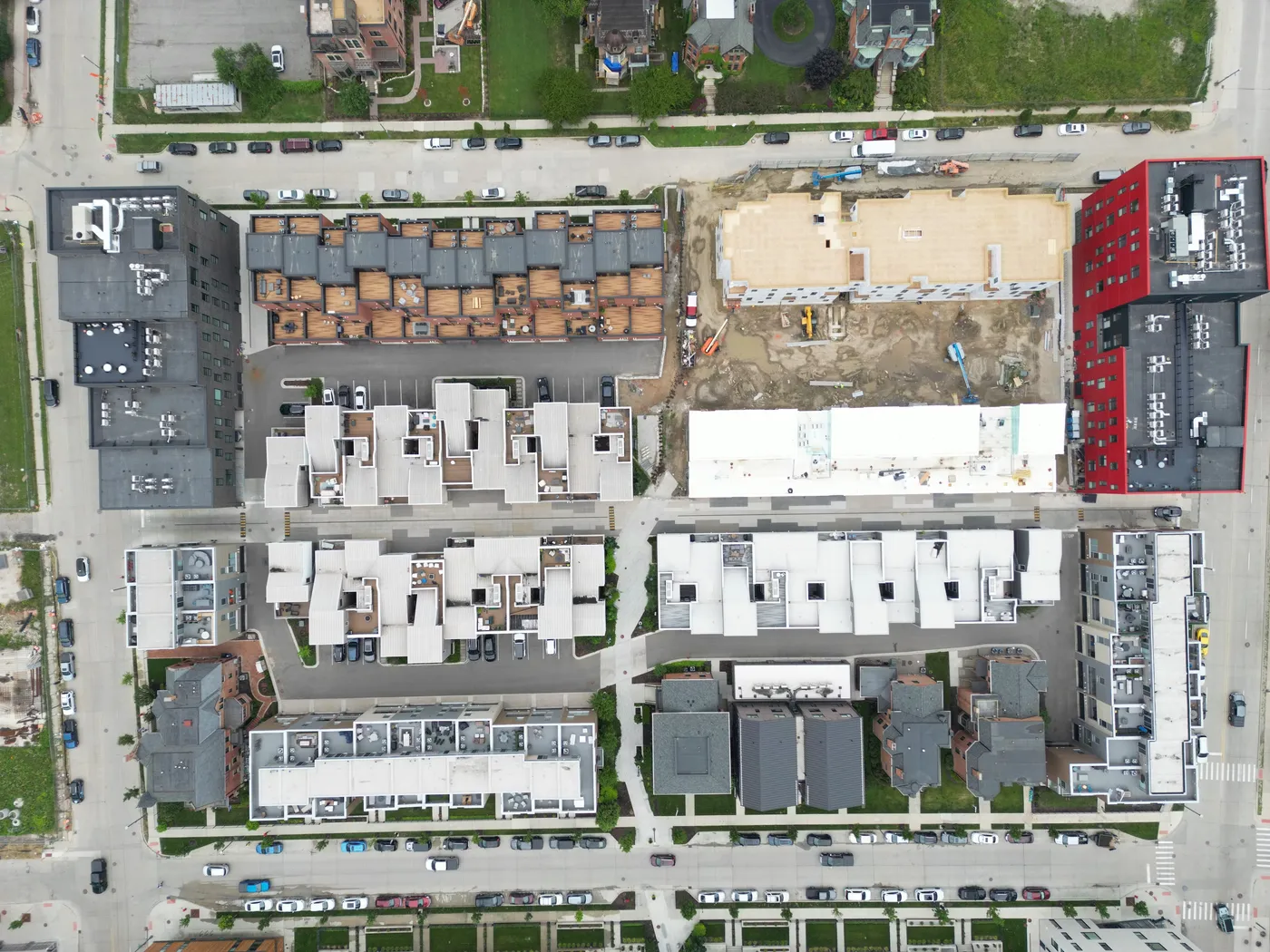 Overhead aerial view of townhome and multi-family developments, one under construction