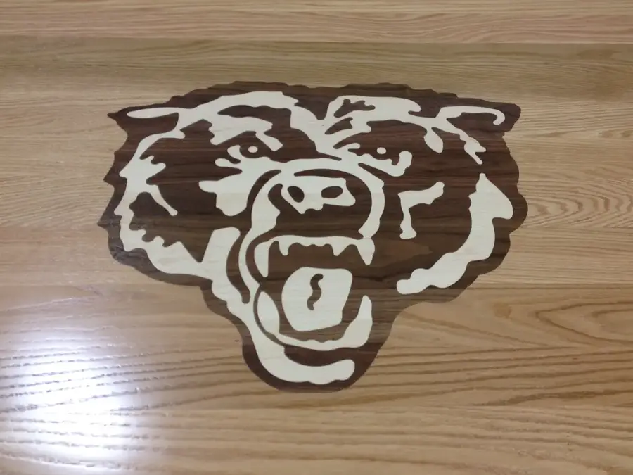 Wood floor inlaid with a snarling bear head mascot