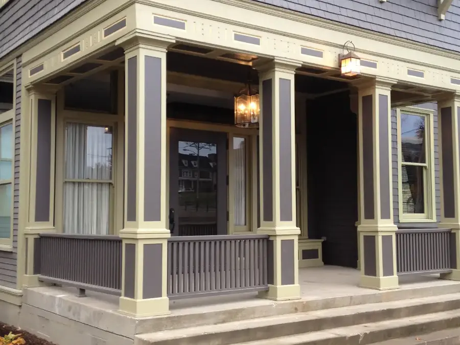 Porch with custom paneled square columns, railings and trim on a historic home