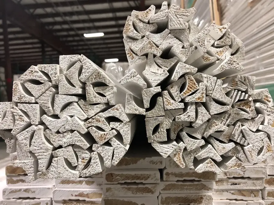 Close-up of the profiled ends of bundled primed moulding