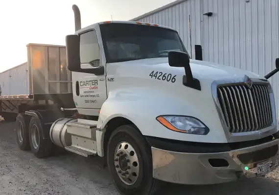 Carter Lumber semi truck parked beside a metal warehouse