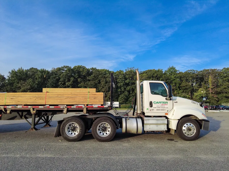 Carter Lumber semi truck hauling a flatbed load of lumber