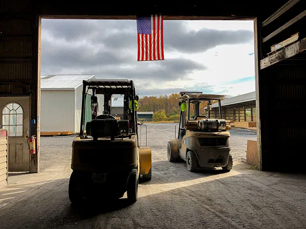 Forklifts and American flag at a Carter Lumber yard