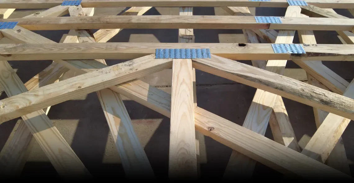 Close-up of wood trusses joined with metal connector plates