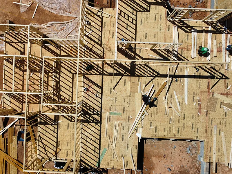 Overhead view of framers working on walls and subfloor of a building