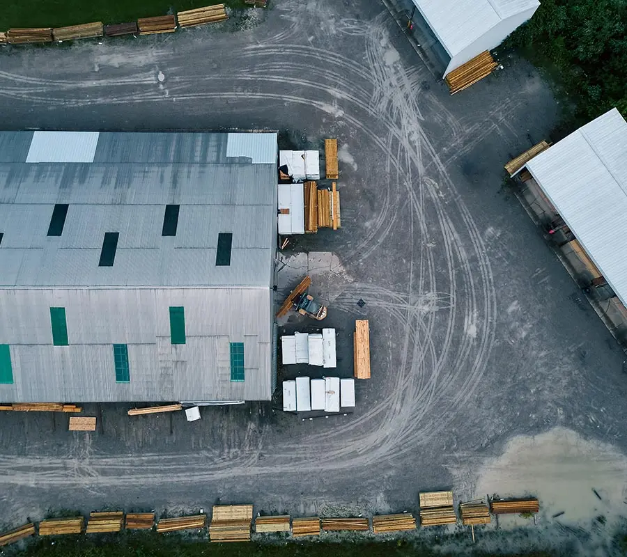 Aerial view of a lumber yard warehouse with stacked materials